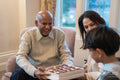Grandfather offering praline to grandson