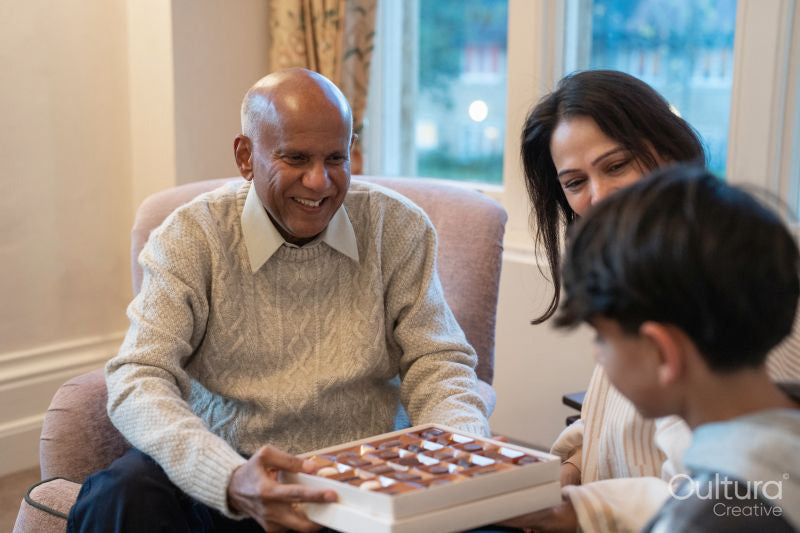 Grandfather offering praline to grandson