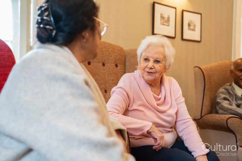 Senior women sitting in room and talking