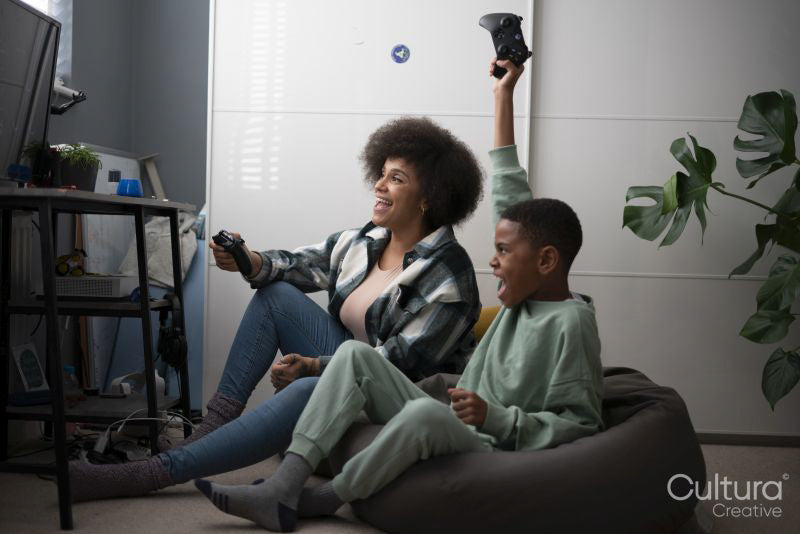 Mother and son playing video games at home