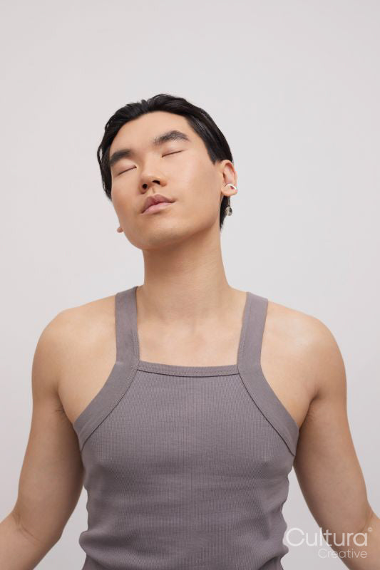 Studio portrait of handsome man with ear piercing