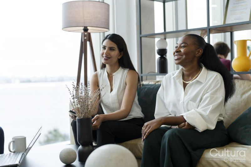 Businesswomen having meeting in office lobby