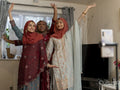 Women posing for picture during Ramadan celebration at home