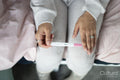 Woman checking pregnancy test, view from above