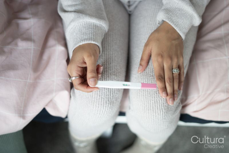 Woman checking pregnancy test, view from above