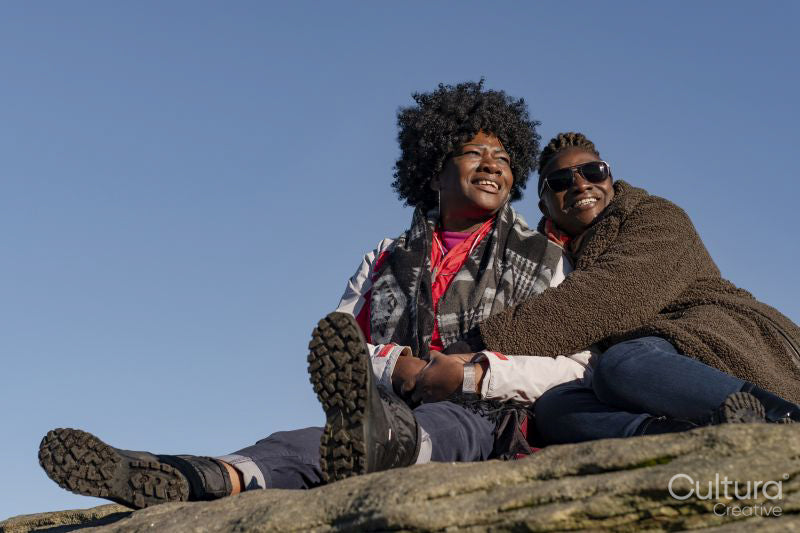 Portrait of two senior women under blue sky