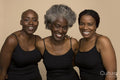Studio portrait of three smiling women in black tops