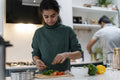 Woman and man preparing food in kitchen