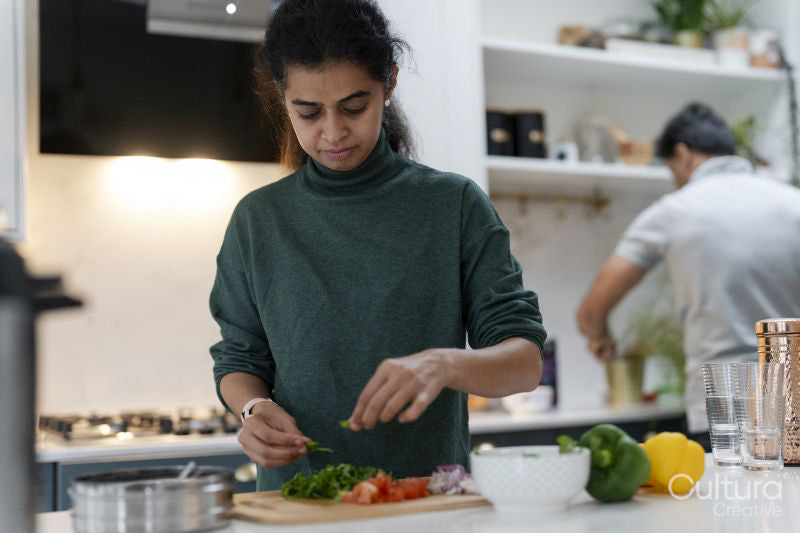 Woman and man preparing food in kitchen