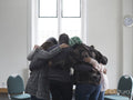 People hugging in group therapy session