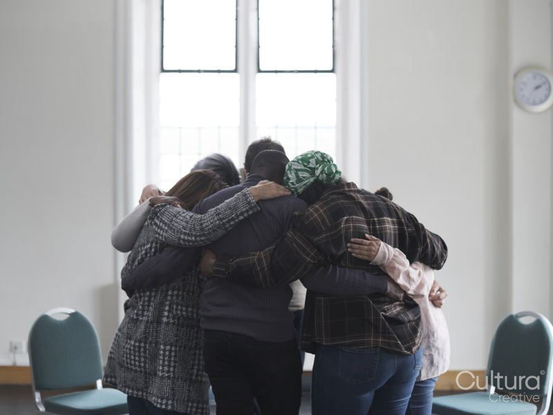 People hugging in group therapy session