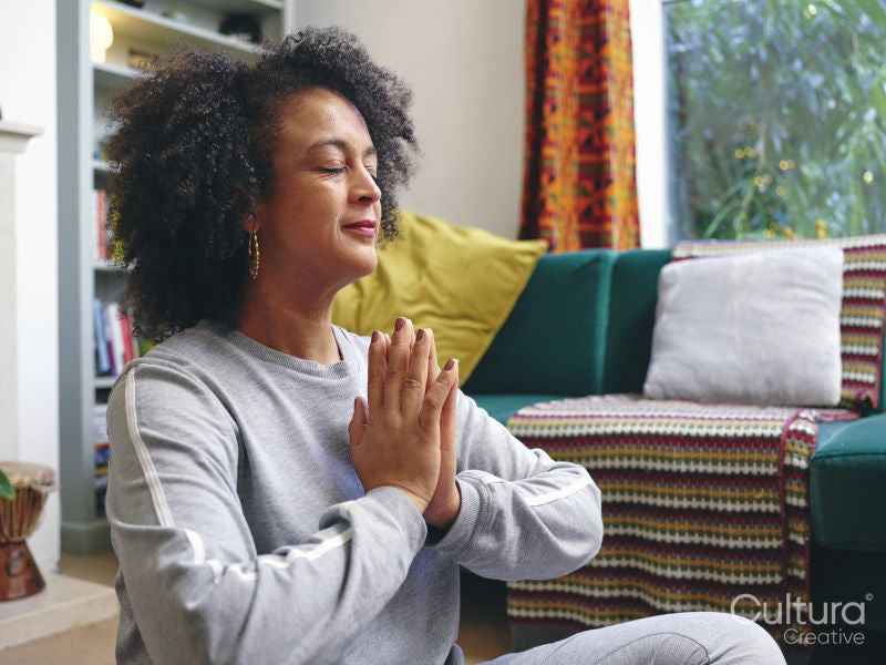 Woman practicing yoga at home