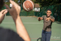 Men playing basketball outdoors