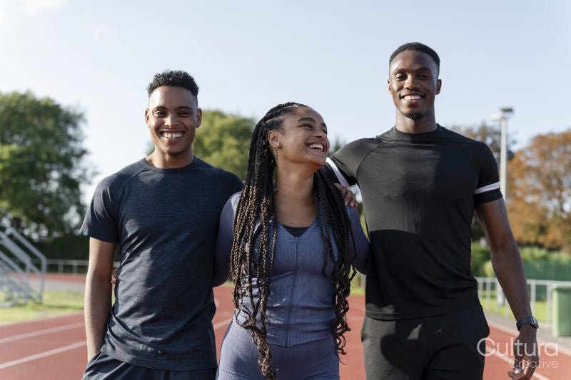 Portrait of group of athletes standing at stadium