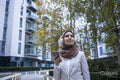 Businesswoman in hijab and headphones standing in city
