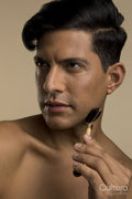 Studio portrait of man using face roller