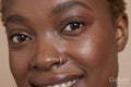 Close-up of smiling woman with nose ring
