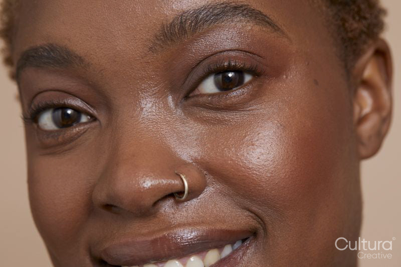Close-up of smiling woman with nose ring