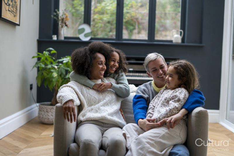Smiling women with daughters at home