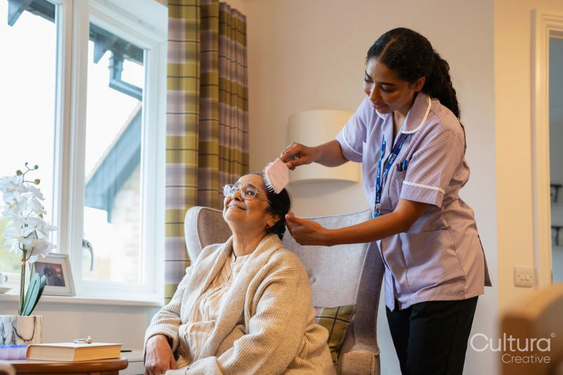 Nurse brushing hair of senior lady at nursing home