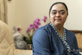 Portrait of young woman with down syndrome at home