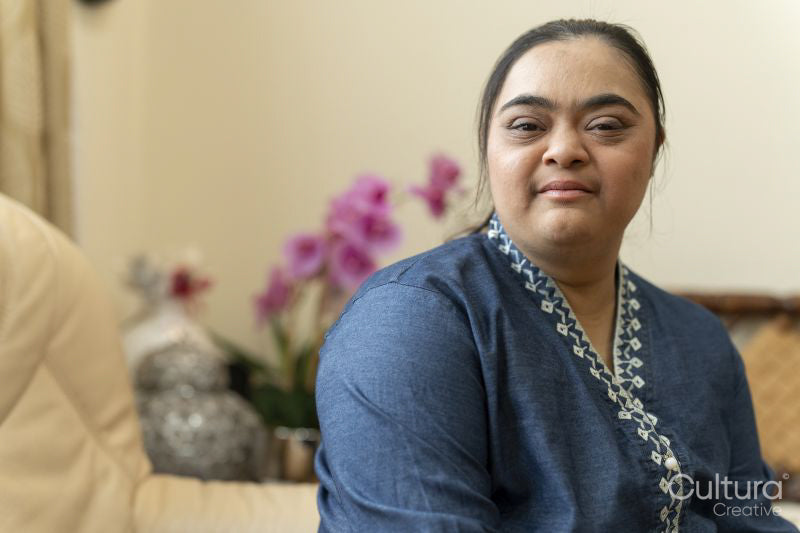 Portrait of young woman with down syndrome at home