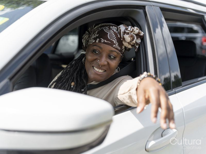 Woman sticking arm through car window