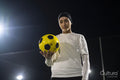 Portrait of female soccer player holding ball