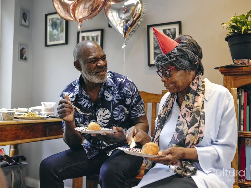 Man and woman eating at birthday party