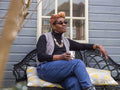 Woman relaxing on bench in backyard