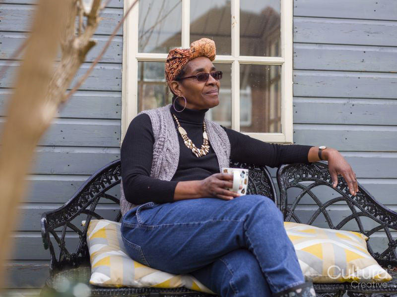 Woman relaxing on bench in backyard