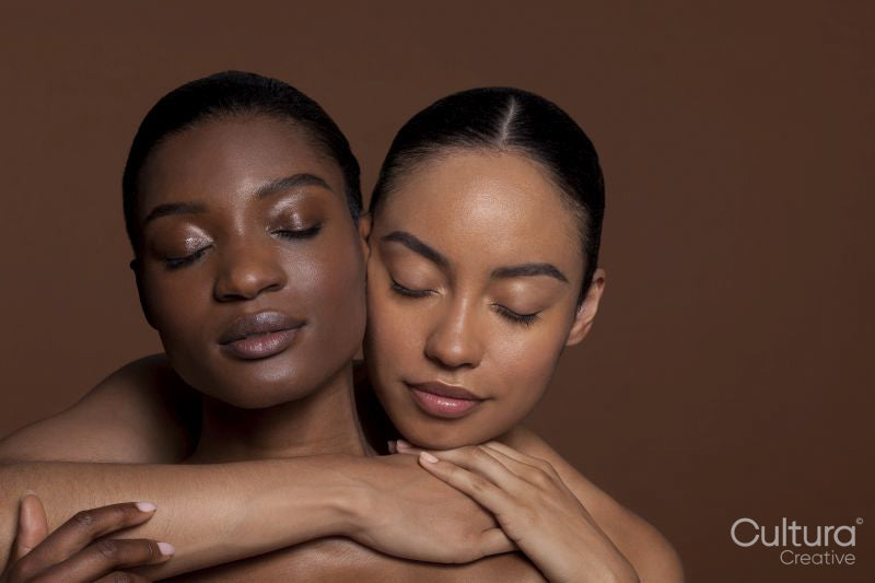 Young women embracing with closed eyes
