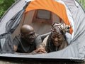 Mature couple relaxing in tent after hike