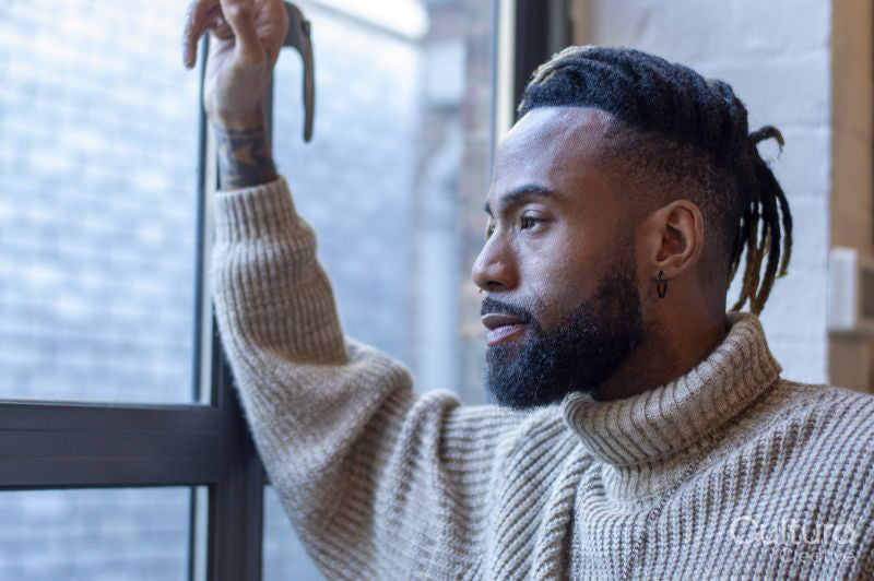 Man looking through window
