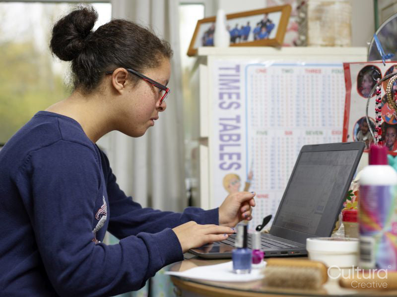 Girl with Down syndrome using laptop