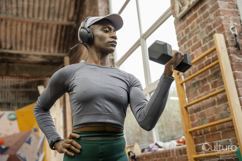 Woman exercising with dumbbells at gym