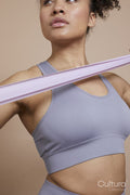 Studio portrait of athletic woman exercising with resistance band