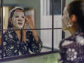 Woman applying face mask in bathroom