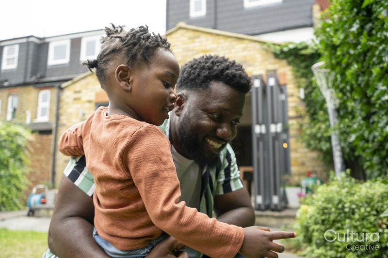 Father and daughter spending time together in backyard