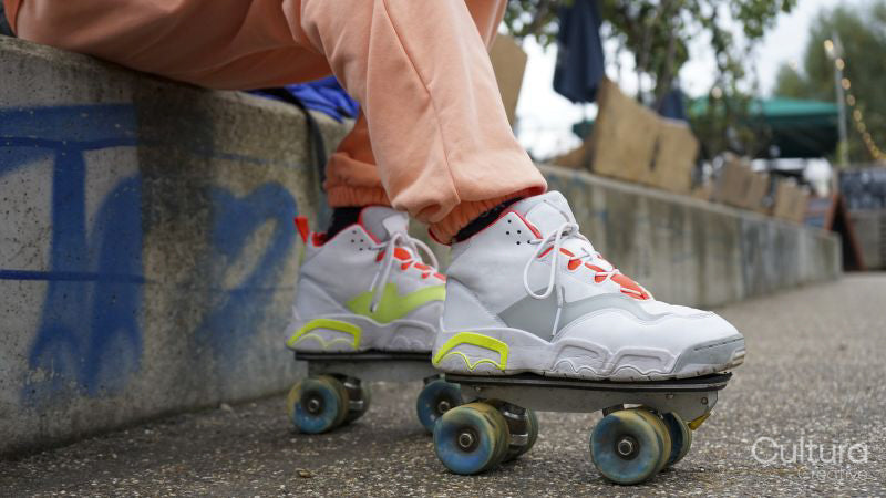 Low section of man wearing roller skates