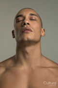 Studio portrait of shirtless man with eyes closed