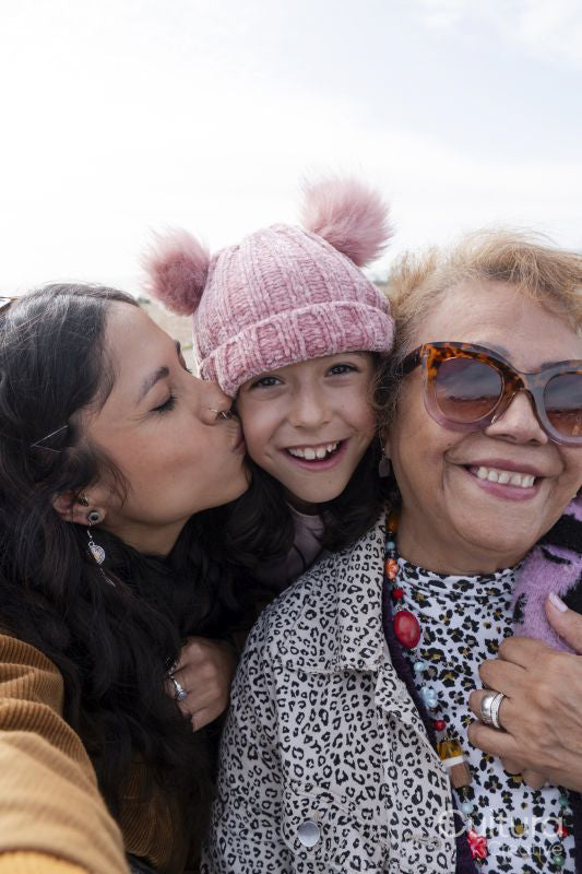 Grandmother, mother and daughter taking selfie