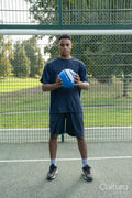Portrait of man standing with soccer ball outdoors