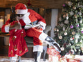 Santa Claus embracing small boy in living room