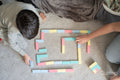 Mother and son playing with toy blocks, view from above
