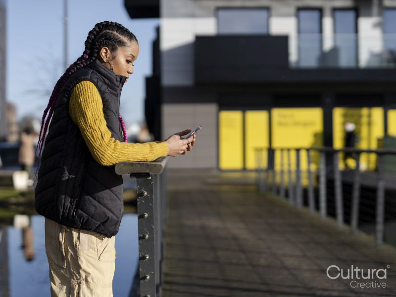 Young woman using phone in urban setting