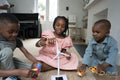 Siblings playing with wind turbine model