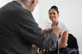 Smiling female doctor talking to senior patient in office