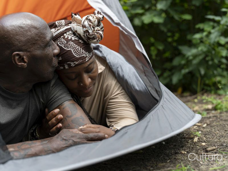 Mature couple relaxing in tent after hike