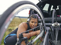 Woman checking bicycle before ride